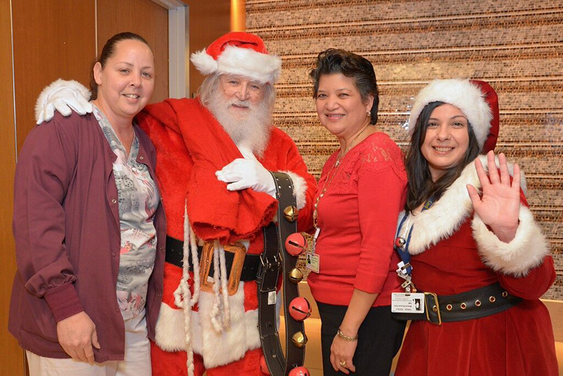 Santa’s Helpers Wrapping Party attendees with Dr. and Mrs. Claus